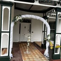 Metal Arch, Drapes, Flowers 